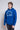 Person wearing a blue 'University of Saint Francis' hoodie against a plain background