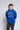 Person wearing a blue 'University of Saint Francis' hoodie against a plain background