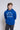 Person wearing a blue 'University of Saint Francis' hoodie against a plain background
